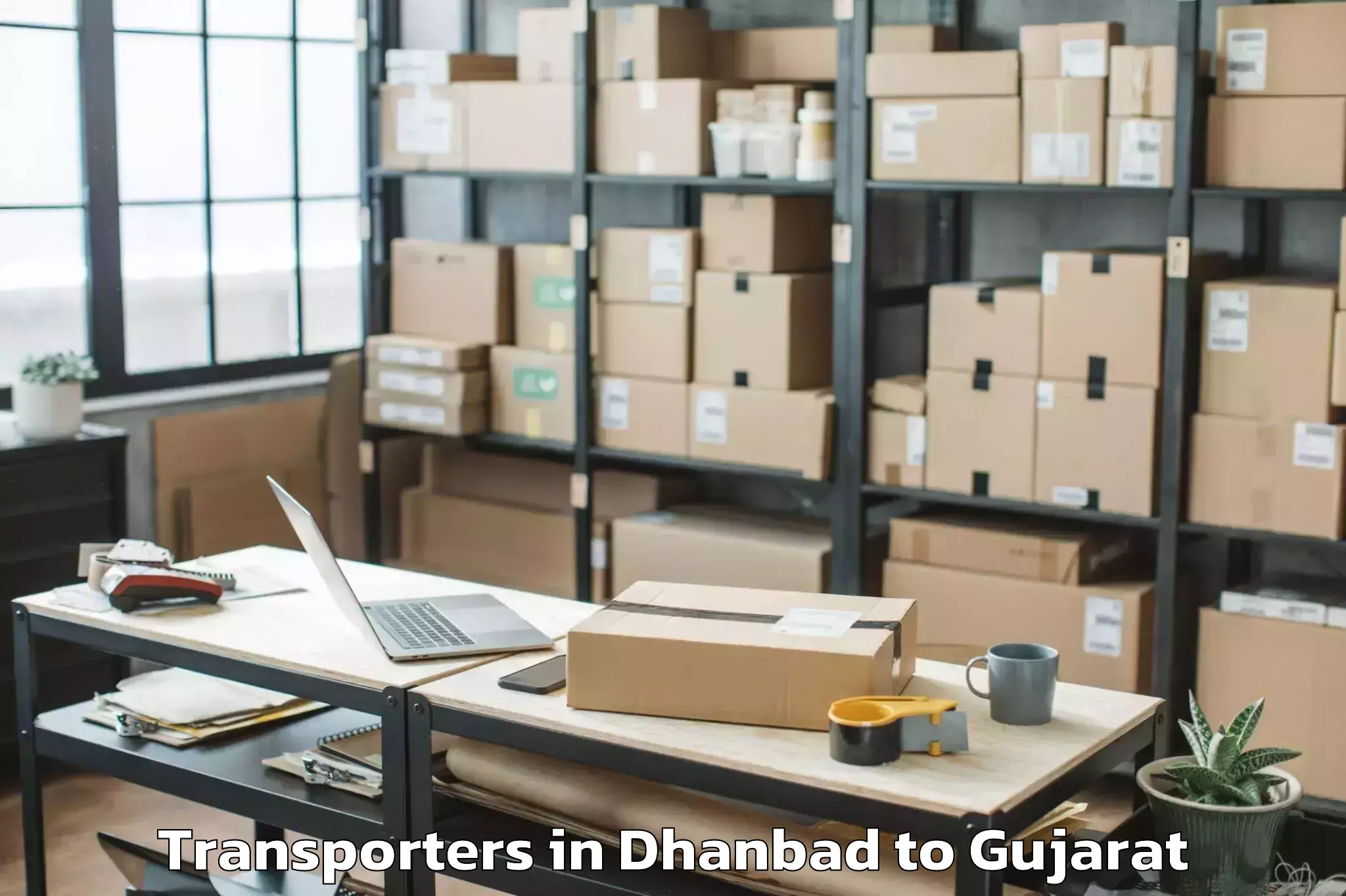 Leading Dhanbad to Tilakvada Transporters Provider